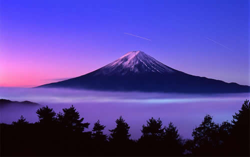 Mountain at sunset rising out of mist; JPG image.